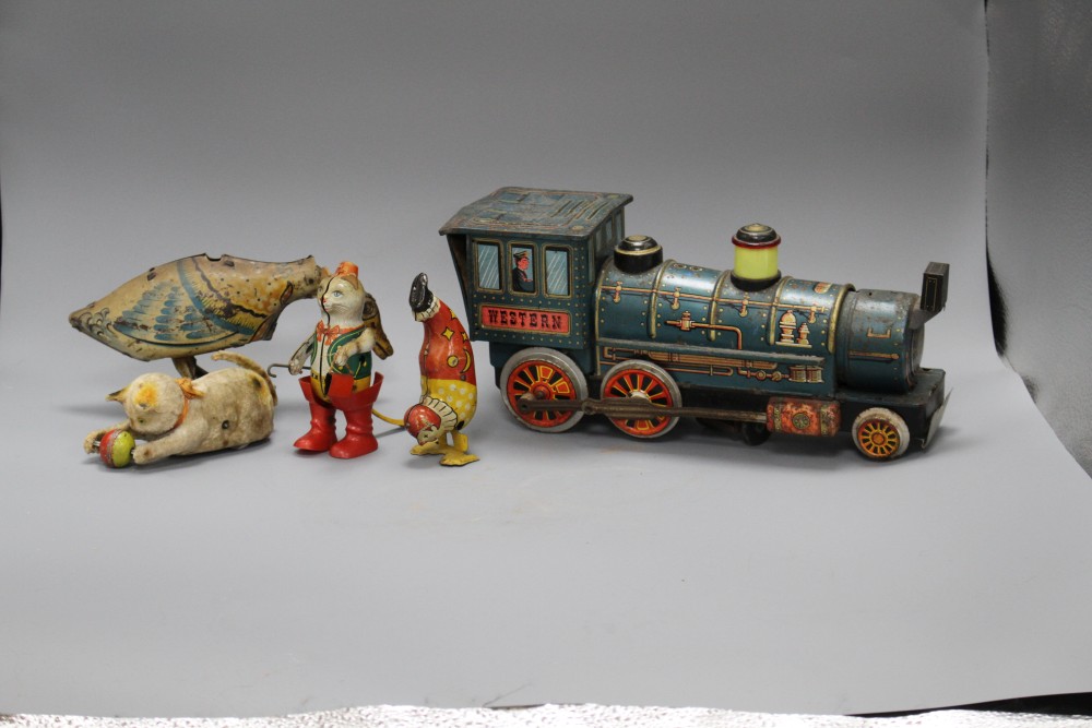 A clockwork cat and ball, and four assorted tinplate toys